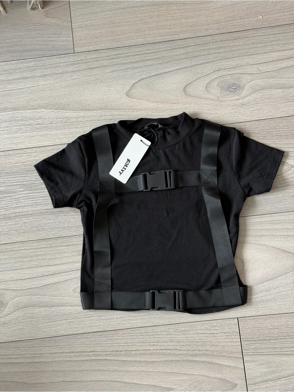 Black fitted tee with buckle detailing